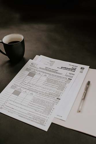 coffee cup black ceramic mug beside white printer paper cup